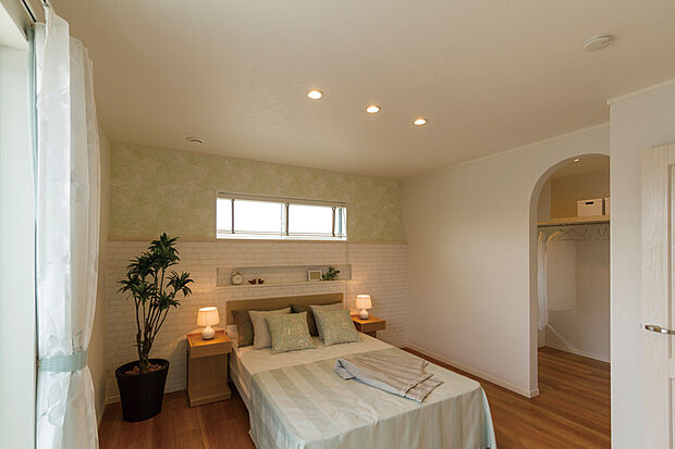 【当社施工例】「つなテラ」に面した開放的な主寝室は、アクセントクロスやダウンライトにより落ち着きがある印象に。大容量のWICとの間に建具がないため、より開放感のある明るい空間を演出します。