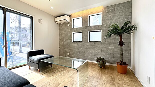 【A号棟LDK】
ご家族が集い、暮らしの中心となるLDKは17帖以上の広さが確保されています。デザイン性のある窓やアクセントクロスが施され、おしゃれな寛ぎ空間です。