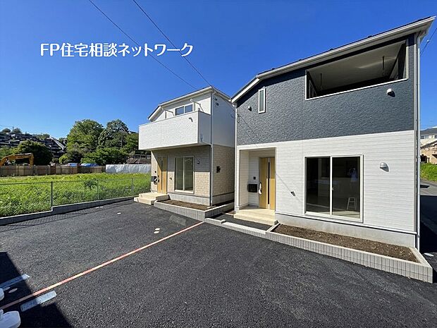 【前面道路含む現地写真】【外観】 青空の下に佇むモダンでスタイリッシュな外観が魅力的で、明るく開放的な暮らしを叶えます。駐車スペースもゆとりがあり、新生活のスタートにふさわしい住まいです。