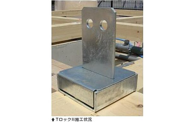 【柱と基礎を固定するオリジナル金物 『TロックII』】柱固定金物の中でも非常に高い性能を持つ「ホールダウン金物」の約2倍の強度があります。台風などの強風に耐えられる耐久性を保ちます。