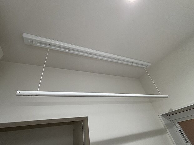 【ホスクリーン】洗面室の天井に設置の昇降式物干し。乾燥機にかけられない衣類はこちらに。洗面室で洗濯が完了します。