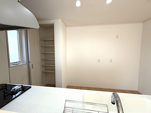 【【9号棟:キッチン収納】】キッチンの反対側には扉つきの収納スペースがあり、可動式の棚がついているので高さも自由に調節できます。