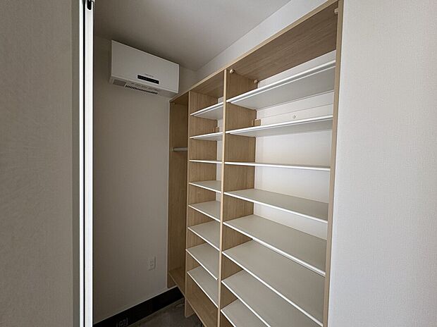 【B2号棟　シューズクローク】壁一面にラックを設けた大容量のシューズクローク