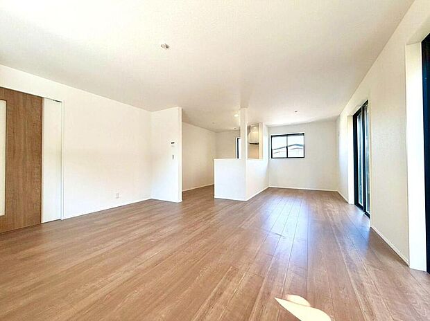 【リビング】南向きの窓から明るい陽光が降り注ぐ、広々としたリビングです。家族の会話が弾む対面キッチンも近く、毎日が笑顔で満たされることでしょう。