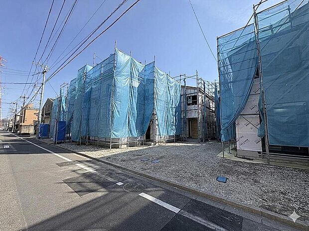 【現地外観写真】青空が広がる建設現場、複数の新築戸建てが並びます。未来の家族の笑顔を育む、新しい暮らしの舞台が着々と形になっています。