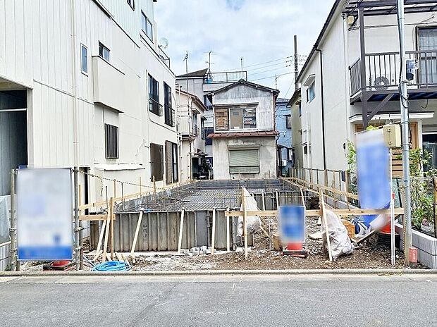 【現地外観写真】現地(2026年7月)撮影
前面道路(幅6m)に面した敷地の基礎工事の様子です。両隣の住宅に挟まれた整形地で、駐車1台分を予定しています。完成予定:2026年11月上旬。