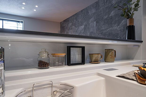 【【キッチン収納】】キッチン前面に腰壁があり、手元部分がリビング側から見えにくい設計です。腰壁の内側は収納スペースになっており、調味料や小物を置くことができます。