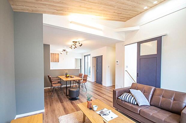 【【本分譲地に建築可能な建物プラン例】】アクセントクロスと木目調の天井がお洒落な空間を生み出すLDK。勾配天井によって、空間をより広く感じます。《分譲地外:建物面積103.07m2、建物価格1851万円》