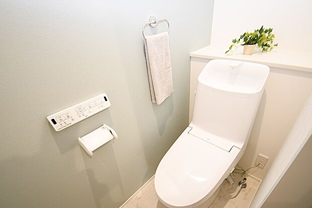 【(2)号棟 トイレ】温水洗浄便座トイレ。新素材により、気になる便座もサッとひとふきでキレイになります。※施工事例です。実際の建物とは異なります。