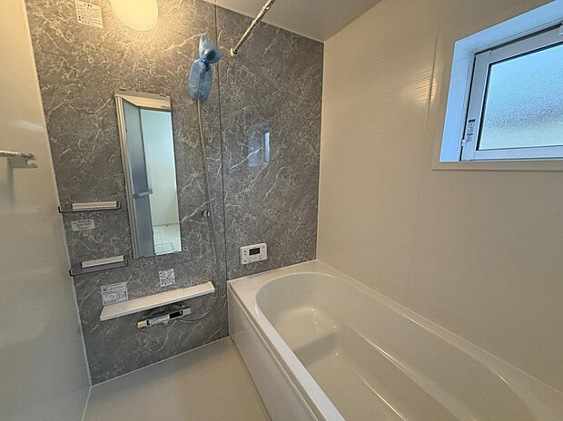 【浴室】シンプルで洗練されたデザインが魅力の1坪バスルーム。落ち着いた色合いのパネルや上質な質感の浴槽が、コンパクトな空間に上品な雰囲気をもたらします。