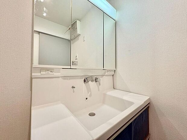 【洗面台・洗面所】収納豊富な三面鏡付き洗面台で、家族の小物もすっきり片付きます。広々とした空間は、お子様との朝の準備もスムーズで快適です。