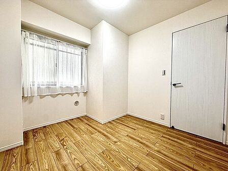 木の温もりを感じさせる床材と白い壁面が調和し、日々の暮らしに静かな安らぎをもたらす、無駄のない洗練された空間です