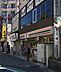周辺：セブンイレブン 久喜駅西口店（564m）