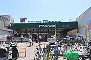 万代布施店 318m