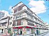 外観：街並みに自然と馴染む色を基調とした外観は、温かみのある色合いが全体を包み、やさしい雰囲気を感じます。(空の加工を生成AIで行っています)