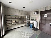 【エントランス】窓からの自然光が差し込む明るいエントランス。管理人室と防犯カメラが備えられており、防犯対策にも心強いです。