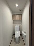 清潔感あふれるトイレ空間。上部収納で空間を有効活用し、洗練されたデザインが毎日の生活に快適さをもたらします。