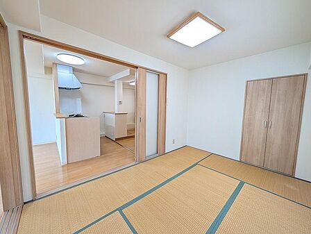 リビングやキッチンと隣接した使い勝手の良い和室です。引き戸を開放すればLDKと一体感のある空間として広く使え、扉を閉めれば個室としても活用可能。収納も完備されています。