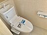 室内：同仕様写真 お掃除しやすい素材と機能にこだわった、シャープなフォルムのトイレはいつまでもキレイが続きます。少ない水量で洗浄できる、環境にもお財布にもやさしいエコなトイレです