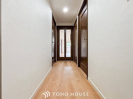 上質感漂う廊下。居住者の帰り、訪れる方を優しく迎える・安らぎに満ちた生活空間を予感させる。