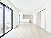 明るい陽光が注ぎ、寛ぎの雰囲気に満たされるリビング・ダイニング。 