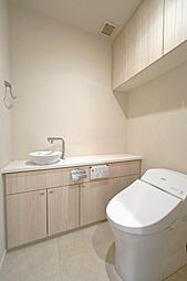 見た目の良さとお手入れのしやすさが両立できるタンクレストイレには温水洗浄暖房便座を採用。また、収納と手洗いも完備しているので使い勝手が良いです。