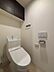 トイレ：清潔感溢れる温水洗浄便座付きトイレです。背面には大容量の吊戸棚を備えており、トイレットペーパーや掃除用品をすっきり収納できます。毎日使う場所だからこそ、シンプルで心地よい空間になっています。