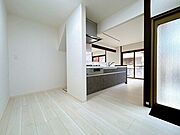 白壁と木目床が開放感を生み、キッチンとも近く使いやすい。食事も会話も心地よく過ごせる、シンプルで快適な空間です。