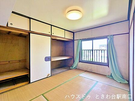 窓から自然光が入る畳敷きの和室です。壁一面には押入れと天袋が設けられており、収納を確保しながら居室部分を有効に使えます。