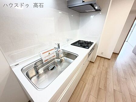 白を基調とした清潔感あふれるキッチン。コンパクトながらも使いやすく、毎日の料理がはかどります。