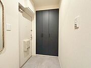 内装新調済の玄関。人感照明、収納完備で機能的。※AI加工画像につき現状と異なります