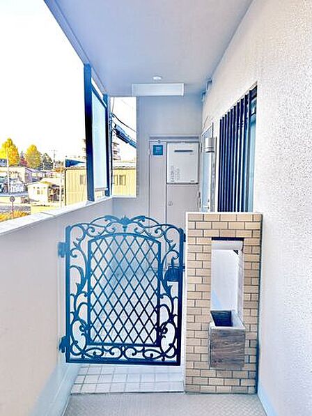 【リフォーム済】玄関（外部）の写真です。角部屋のため、専用ポーチがついております。ちょっとしたお荷物をポーチ内に置くことができます。また、ドアの前を通行する人がいない