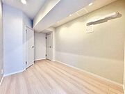 5.7帖の洋室～リビングと統一感のある明るい色の床材が採用されており、お部屋全体を広く清潔感のある印象に見せています。大きな荷物も収納できるマルチWIC付です。