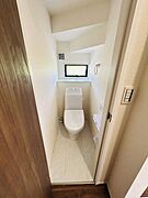 窓が配置されており換気や明るさが確保しやすいトイレです。コンパクトながらも機能的に設計されています。手洗いカウンターやペーパーホルダーも配置されています。清潔感のある内装が特徴です。