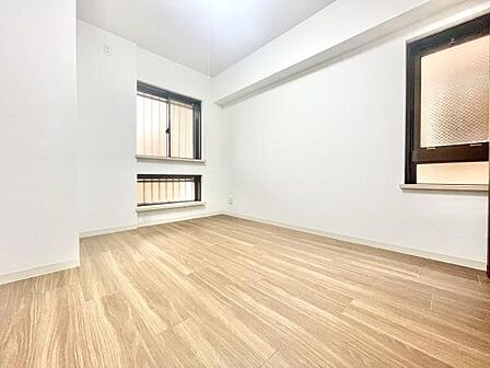 明るい色合いのフローリングが空間を広く感じさせます。大きめの窓があり自然光がしっかり入ります。壁面はシンプルで家具の配置がしやすいです。無駄のない設計で日々の使い勝手も良好です。