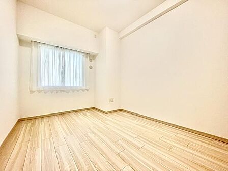 明るい色合いのフローリングが印象の寝室です。窓からやわらかな光が入る空間になっています。壁や天井がシンプルにまとまっていて使いやすいレイアウトが可能です。清潔感のある雰囲気が広がっています。