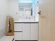 清潔感のある白を基調とした洗面台が空間を明るく見せています。大きなミラーが設置され身支度がしやすい印象です。収納スペースも豊富で洗面所の片付けがしやすそうです。
