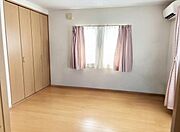 明るい光が差し込む洋室です。ナチュラルなフローリングがより明るい印象を与えます。収納スペースがしっかり確保されています。