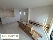 リビングには窓から心地よい光が差し込み明るい空間が広がっています。床はナチュラルな色合いで落ち着いた印象を与えます。シンプルな設計が特徴で家具のレイアウトもしやすいです。