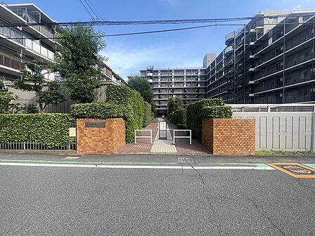 手入れの行き届いた緑とレンガ造りの門構えが、日常の往来に安らぎを添える静謐なアプローチです