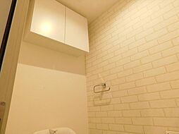 [トイレ] 【施工例／トイレ上部棚】トイレットペーパーのストックや掃除用具などを収納できる吊戸棚が備わっています。 
